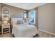 Cozy bedroom with a decorative window, neutral paint, and coordinated decor at 2897 Elio Hammock Dr, St Cloud, FL 34773