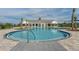 Beautiful community pool with a zero entry, palm trees, and lounge area at 2897 Elio Hammock Dr, St Cloud, FL 34773