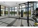 Well-equipped gym with workout equipment, medicine balls, large windows offering a view of the neighborhood pool at 2897 Elio Hammock Dr, St Cloud, FL 34773