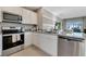 Elegant kitchen featuring stainless steel appliances, granite countertops, and ample natural light at 2897 Elio Hammock Dr, St Cloud, FL 34773