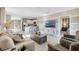 A modern living room with a large TV, a dining area, and an open concept at 2897 Elio Hammock Dr, St Cloud, FL 34773