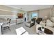 Bright living room featuring comfortable seating, neutral decor, and seamless flow into the dining area at 2897 Elio Hammock Dr, St Cloud, FL 34773