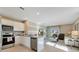 Open concept living area with a modern kitchen and cozy lounge area with comfortable seating at 2897 Elio Hammock Dr, St Cloud, FL 34773