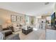 Bright, open-concept living room featuring modern furniture and tile floors throughout at 2897 Elio Hammock Dr, St Cloud, FL 34773