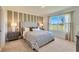A well-lit main bedroom with large windows, neutral walls, and carpet flooring at 2897 Elio Hammock Dr, St Cloud, FL 34773