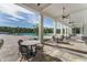 Relaxing outdoor patio area with poolside seating and covered columns at 2897 Elio Hammock Dr, St Cloud, FL 34773