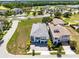 Aerial view of beautiful property on corner lot, well manicured landscaping and a three car garage at 300 Muirfield Loop, Reunion, FL 34747
