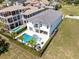 Aerial view of a stunning property with a pool, palm trees and a nice fenced in area at 300 Muirfield Loop, Reunion, FL 34747