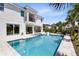 Expansive pool and backyard featuring an outdoor kitchen and seating areas, blending luxury and comfort at 300 Muirfield Loop, Reunion, FL 34747