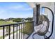 Balcony includes hanging swing chair overlooking neighborhood at 300 Muirfield Loop, Reunion, FL 34747