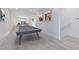 Bright open finished basement with pool table and stairs leading to another room at 300 Muirfield Loop, Reunion, FL 34747