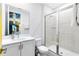 Modern bathroom featuring a glass-enclosed shower, sleek vanity with sink, and clean, contemporary fixtures at 300 Muirfield Loop, Reunion, FL 34747