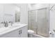 Clean bathroom featuring a walk-in shower with modern tile, a vanity with sink, and contemporary fixtures at 300 Muirfield Loop, Reunion, FL 34747
