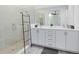 Bathroom with double vanity, tile shower, and black towel ladder at 300 Muirfield Loop, Reunion, FL 34747