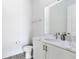 Modern half bath features a white vanity, sleek sink, and contemporary fixtures for a clean, minimalist aesthetic at 300 Muirfield Loop, Reunion, FL 34747