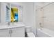 A clean bathroom includes modern fixtures, a bathtub-shower combination, and neutral tones creating a serene retreat at 300 Muirfield Loop, Reunion, FL 34747