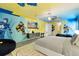 A unique room with custom sports-themed wall art, modern furnishings, and vibrant decor for a unique touch at 300 Muirfield Loop, Reunion, FL 34747