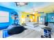Fun, sports-themed room featuring custom hockey murals, a unique beanbag, and decor for the young sports fan at 300 Muirfield Loop, Reunion, FL 34747