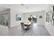 Dining room with large table, chairs, modern light fixture, and view of the pool at 300 Muirfield Loop, Reunion, FL 34747