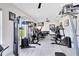 Well-equipped home gym with various weight machines and fitness equipment for a complete workout at 300 Muirfield Loop, Reunion, FL 34747