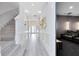 Bright hallway with staircase and view into a home movie theater at 300 Muirfield Loop, Reunion, FL 34747