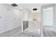 Bright hallway with modern railings, stylish light fixtures, and doors leading to various rooms at 300 Muirfield Loop, Reunion, FL 34747
