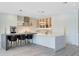Elegant kitchen features a large island, breakfast bar, pendant lighting, and high-end stainless steel appliances at 300 Muirfield Loop, Reunion, FL 34747