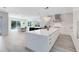 Spacious kitchen with center island, stainless hood, pendant lights, and backyard pool view at 300 Muirfield Loop, Reunion, FL 34747