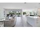 Large living room with pool views and access, leading into the dining room and kitchen at 300 Muirfield Loop, Reunion, FL 34747
