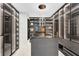 A modern walk-in closet offers ample storage, sleek finishes, and illuminated shelving for organized luxury at 300 Muirfield Loop, Reunion, FL 34747