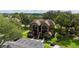 Aerial view of condo buildings with balconies surrounded by lush green trees and a parking lot with marked spaces at 315 Lakepointe Dr # 101, Altamonte Springs, FL 32701