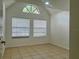 Bright bedroom with vaulted ceilings, two large windows with blinds, and neutral tile floors at 315 Lakepointe Dr # 101, Altamonte Springs, FL 32701