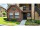Condo exterior showcasing a red brick accent wall with black trim and a well-manicured lawn and tidy landscaping at 315 Lakepointe Dr # 101, Altamonte Springs, FL 32701