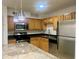 Well-lit kitchen featuring stainless steel appliances, light wood cabinets, granite countertops, and modern pendant lighting at 315 Lakepointe Dr # 101, Altamonte Springs, FL 32701