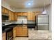Bright kitchen with stainless steel appliances, light wood cabinets, dark countertops, and tiled flooring at 315 Lakepointe Dr # 101, Altamonte Springs, FL 32701
