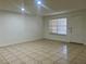 Bright living area with tile flooring, a window, and a white door leading to the exterior of the home at 315 Lakepointe Dr # 101, Altamonte Springs, FL 32701