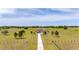 Aerial view of estate with long private driveway and mature landscaping in gated, fenced acreage at 35651 Huff Rd, Eustis, FL 32736