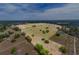 Expansive aerial view highlighting the property's vast open land with scattered trees, perfect for outdoor activities at 35651 Huff Rd, Eustis, FL 32736