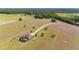Aerial view of home with pool, lush landscaping, long driveway, and fenced acreage for privacy and recreation at 35651 Huff Rd, Eustis, FL 32736