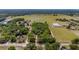 Aerial view of land with combination of grassy field, trees, and buildings along the road at 35651 Huff Rd, Eustis, FL 32736