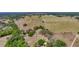 Expansive aerial view of fenced acreage featuring lush pastures, mature trees, and a long driveway leading to a home at 35651 Huff Rd, Eustis, FL 32736