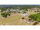 Scenic aerial shot of property featuring green fields and buildings nestled among lush trees at 35651 Huff Rd, Eustis, FL 32736