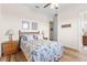 Bright bedroom with hardwood floors, ceiling fan, and door to bath at 35651 Huff Rd, Eustis, FL 32736