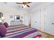 Bedroom with decorative striped blanket on bed, a dresser, and ceiling fan at 35651 Huff Rd, Eustis, FL 32736