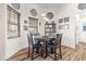 Cozy breakfast nook features a round wooden table set and elegant decorative accents, filled with natural light at 35651 Huff Rd, Eustis, FL 32736
