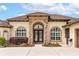 Elegant front entrance with beautiful stone work and landscaping at 35651 Huff Rd, Eustis, FL 32736