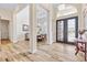 Inviting foyer with wood-look tile and grand double doors at 35651 Huff Rd, Eustis, FL 32736