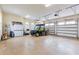 Well-lit three-car garage with an epoxy floor and ample space for vehicles and storage at 35651 Huff Rd, Eustis, FL 32736