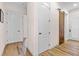 Bright hallway featuring wood-look tile flooring and white doors, showcasing a modern and clean aesthetic at 35651 Huff Rd, Eustis, FL 32736