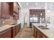 Spacious kitchen featuring granite counters, tile backsplash, custom cabinets and stainless steel appliances at 35651 Huff Rd, Eustis, FL 32736